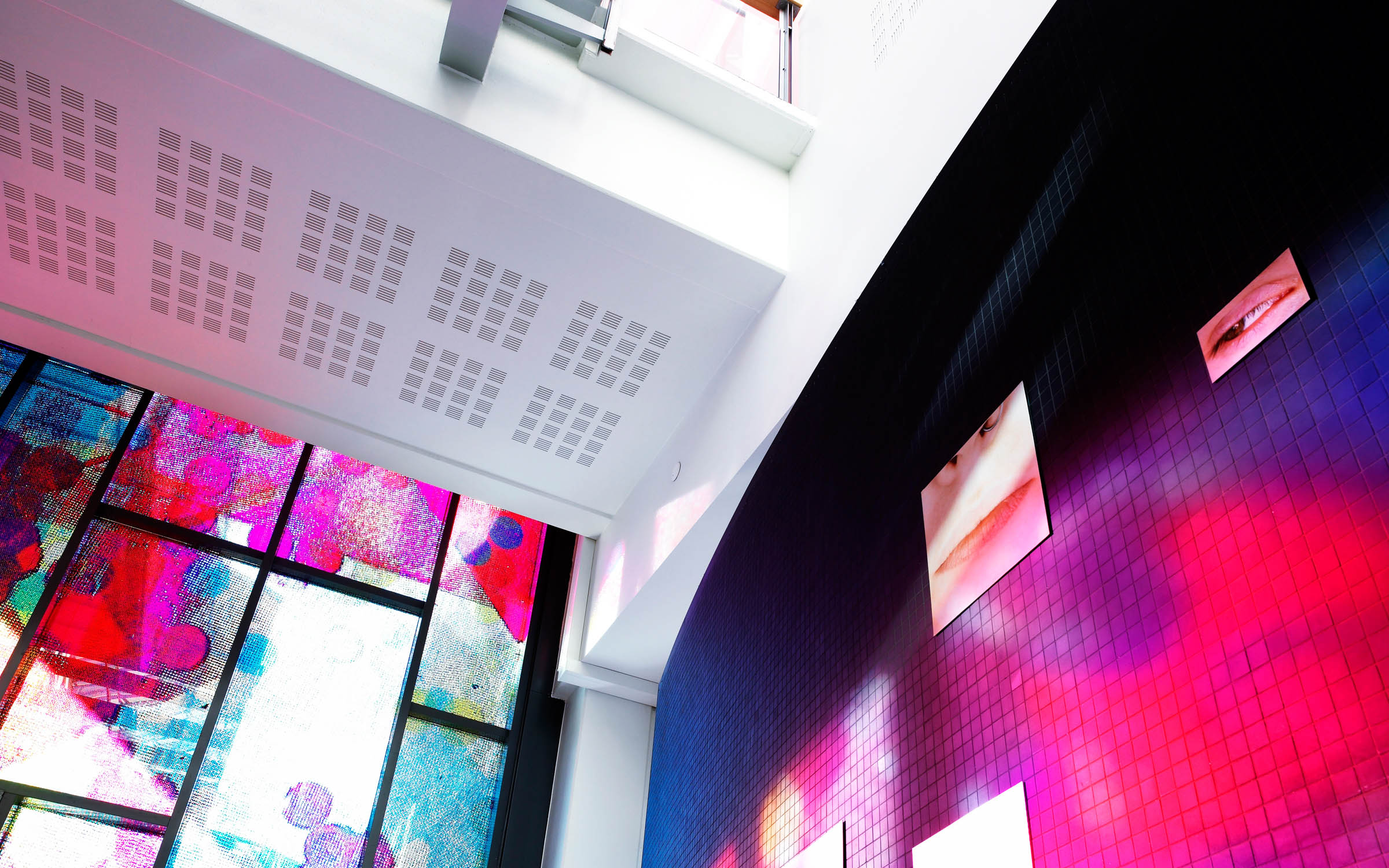 Acoustic panels on walls and ceilings with bright coloured designs